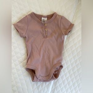 Ribbed Basic Baby Onesie in Dusty Pink with button neckline